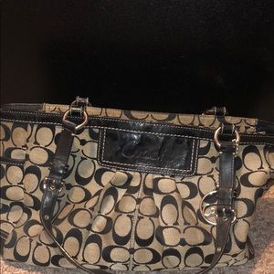 Tan and black Coach pocketbook.